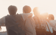 a group of people are standing together with their arms around each other