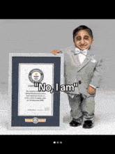 a man in a suit and bow tie is holding a guinness world record certificate