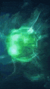 a green glowing object is floating in the dark water