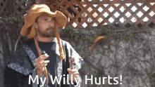 a man with a beard wearing a hat and a robe says my willy hurts