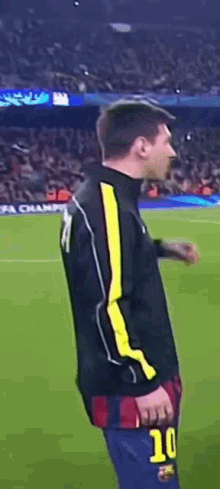 a soccer player with the number 10 on his shorts is standing on the field