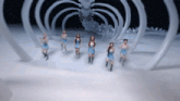 a group of girls are dancing in front of a large skeleton