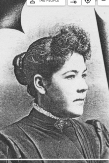 a black and white photo of a woman with a collar and a bun