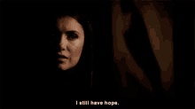 a woman with blood on her face is saying i still have hope .