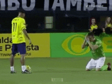 a soccer player in a yellow shirt with the number 11 on it