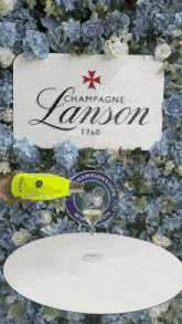 a bottle of champagne lanson is poured into a glass on a table