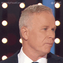 a close up of a man 's face with the words family feud canada on the bottom right