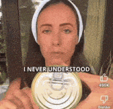 a woman is holding a can that says i never understood on it