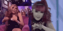 two women are sitting next to each other on a couch and talking to each other .