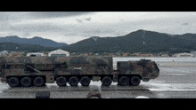 a large military vehicle is parked in a parking lot
