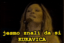 a woman singing into a microphone with jesmo znali da si kukavica