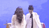 two women standing next to each other with the words nineteen twenties written on the bottom right