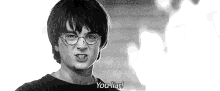 harry potter is wearing glasses and making a funny face .