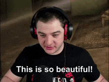 a man wearing headphones and a black shirt says this is so beautiful !