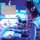 a woman wearing headphones and a microphone is playing a video game .