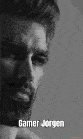 a black and white photo of a man with a beard and the words gamer jorgen on the bottom