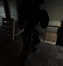 a person in a dark room with a wooden box on the floor