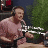 a man wearing headphones says i 've got coffee in my veins dawg
