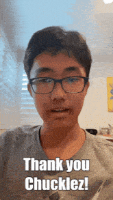 a young man with glasses says thank you chuckles