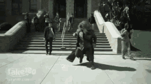 a man in a suit is running down a sidewalk in front of a building with the website take180.com on the bottom