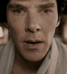 a close up of a man 's face with a very serious look on his face