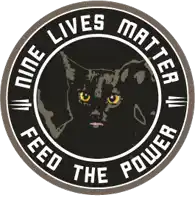 a sticker that says " nine lives matter feed the power " with a black cat in the center