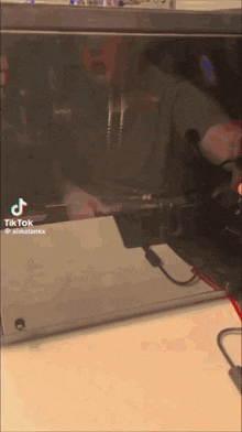 a tiktok video of a person using a laptop computer