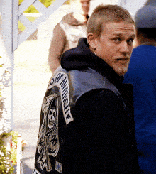 a man wearing a sons of anarchy leather vest