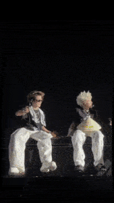 two people sitting next to each other with one holding a bag that says ' a ' on it