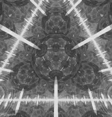 a black and white image of a kaleidoscope with a lot of lights coming out of it