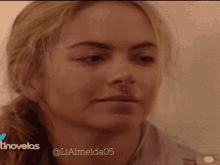 a close up of a woman 's face with the words tinovelas on the bottom