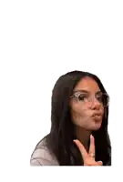 a woman wearing glasses and a ring on her finger is blowing a kiss
