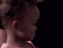 a man with a tattoo on his neck is holding a woman 's head .