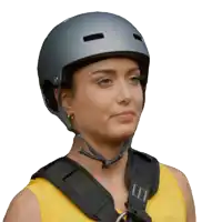 a woman wearing a gray helmet and a yellow tank top