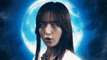 a woman with red eyes is standing in front of a blue moon