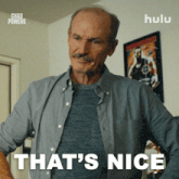 a man with a mustache is standing in front of a sign that says " that 's nice "