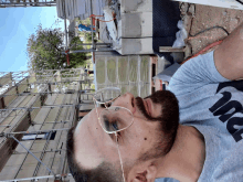 a man wearing glasses and a gray shirt with the word nike on it