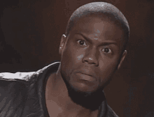 a close up of a man 's face with a surprised look on his face