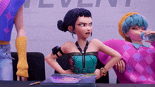 a girl in a pink sweater is drinking water while another girl looks on