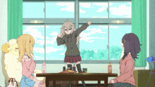a girl stands in front of a table with a bottle of orange juice