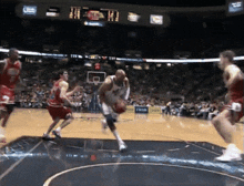 a basketball game is being played in front of a crowd and a scoreboard that says " tnt " on it
