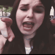 a woman is making a funny face with her tongue out