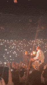 a person playing a piano in front of a crowd