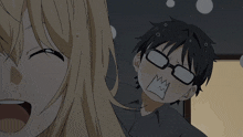 a boy with glasses is making a funny face next to a girl with her mouth open