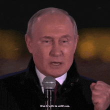 a man is speaking into a microphone and the power is in the truth