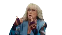 an older woman wearing glasses and a blue vest making a funny face