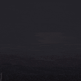 a dark background with a few bubbles of water coming out of it