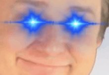 a close up of a person 's face with glowing blue eyes .