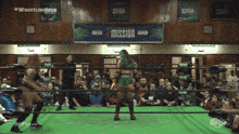 two women in a wrestling ring with a sign that says mission
