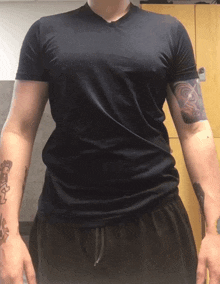 a person with a tattoo on their arm is wearing a black shirt